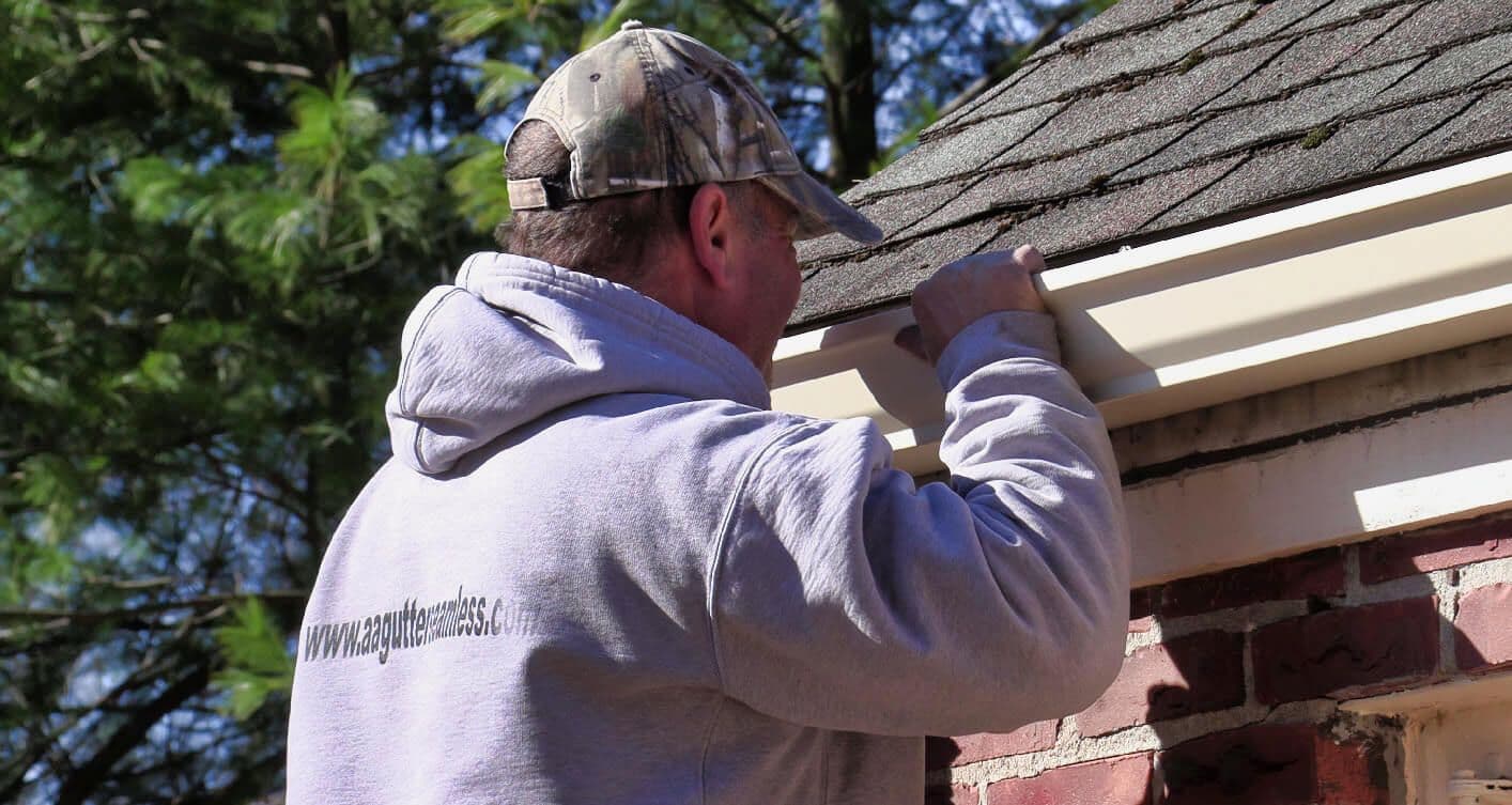 Close-up of A&A worker adjusting gutter section